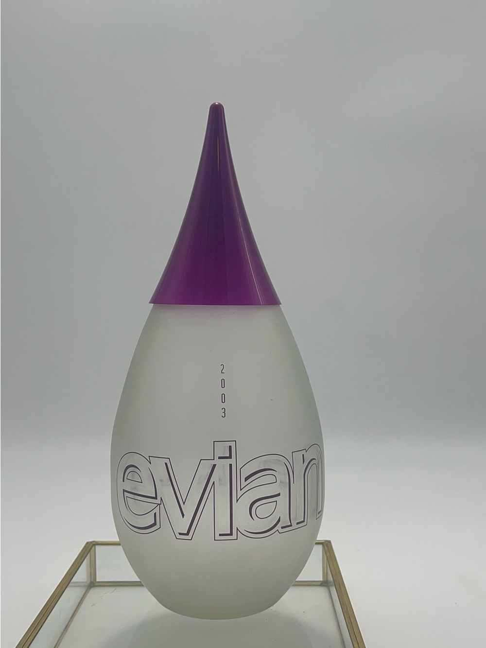 Clear frosted Evian glass water bottle with Purple Cap